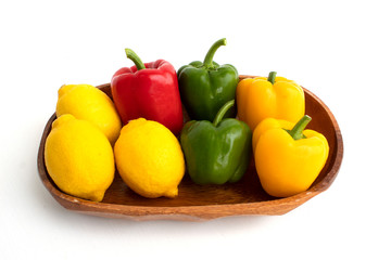 colerful bell peppers and lemon on white background