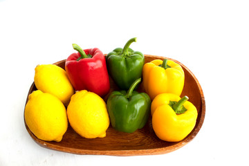 colerful bell peppers and lemon on white background