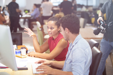Successful team at work. Group of young business people working and communicating together in creative office