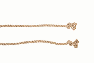 lines of brown jute ropes with knots isolated on white