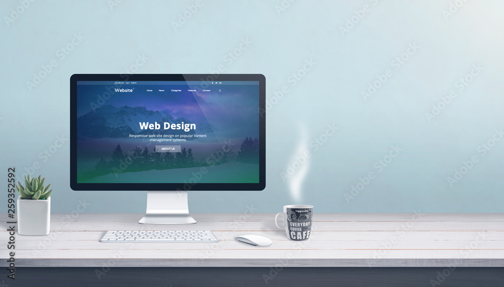 Poster Web design studio with computer display, keyboard and mouse on office work desk. Modern flat design web page on display. Copy space beside.