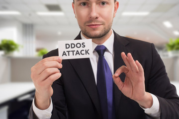 Business, technology, internet and networking concept. Young entrepreneur showing keyword: Ddos attack