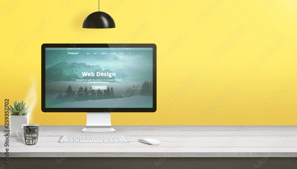 Aufkleber Web design studio work desk with computer display, keyboard, mouse, plant and cup of coffee. Copy space beside on yellow wall.