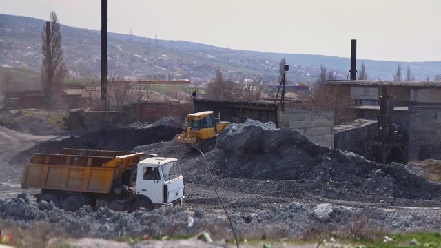 Big truck rides through the territory of a brick factory
