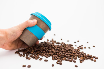 Man Holding Coffee cup to Go with Coffee Beans on the white Background