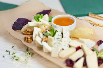 Various types of cheese composition on wooden board