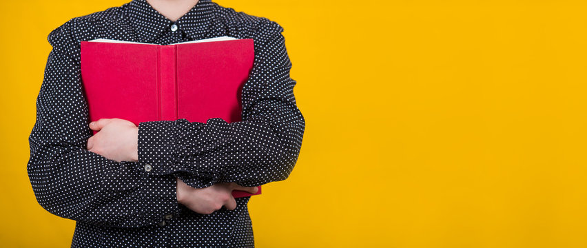 Woman Holding Book To Chest