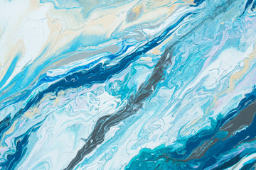 Abstraction painting in blue colors painted with liquid acrylic as a background.