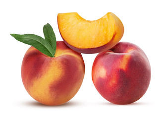 Two ripe peach fruit with leaf and slice