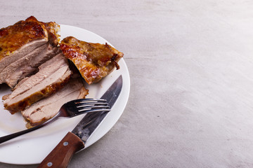 Thigh turkey baked in the oven with spices on a white plate on the tabletop. Healthy food....