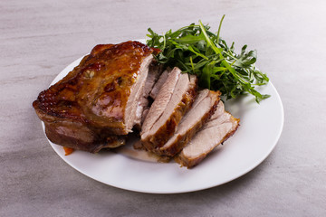 Thigh turkey baked in the oven with spices on a white plate on the tabletop. Healthy food....