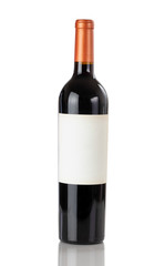 Unopen bottle of red wine isolated on a white background with reflection