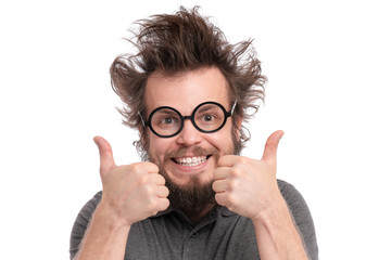 Crazy Bearded happy Man with funny Haircut in Eyeglasses making Thumbs up gesture. Cheerful and...