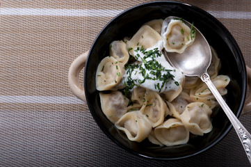 Homemade dumplings with sour cream.