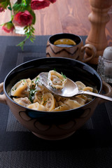 Homemade dumplings with sour cream.