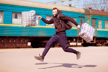 man with big bags at railway station. Travel by train