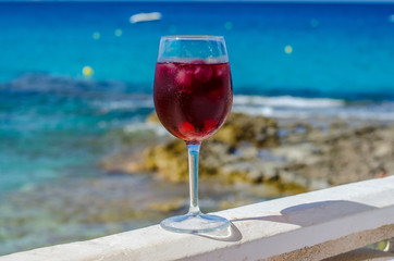 Glass of sangria by a sea bar