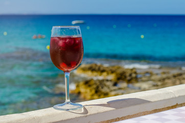 Glass of sangria by a sea bar