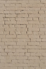Painted brick wall. Texture, background. Light beige color. Vertical frame.