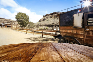 Fototapeta na wymiar Wooden old table of free space and Wild West background 