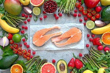 Selection of healthy vegetables with fish on light background. Top view. Diet food.