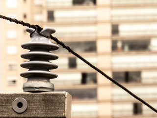 Detail of street electric pole with residential building unfocused