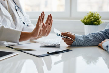 A female doctor refuses a bribe from her patient