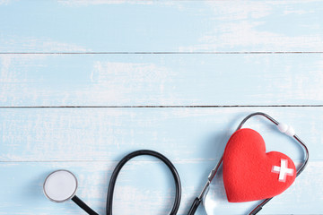 World health day, healthcare and medical concept, health insurance concept. Red heart with stethoscope on blue and white pastel wooden background.