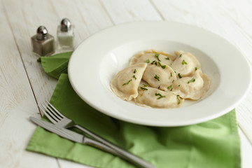 dumplings with potatoes on a white plate