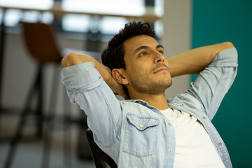 Businessman in office leaning back