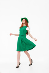 Happy young redheaded girl wearing green hat