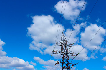 Shot Of A Pylon Against A Blue Sky. Blue Sky And White Clouds Background.