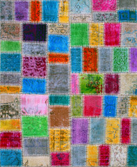Colorful vintage patchwork rug with ethnic design.