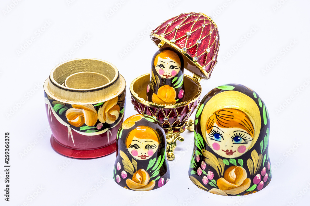 Wall mural Matryoshka family. Matrioska art Russian doll and Russian souvenir, egg casket copy of Faberge on a White background