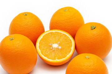 oranges and sliced orange on white background