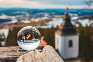 Crystal ball landscape shot with a church near Rinchnach-Bavaria-Germany