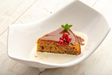 date cupcake on cream in a white plate on a light background