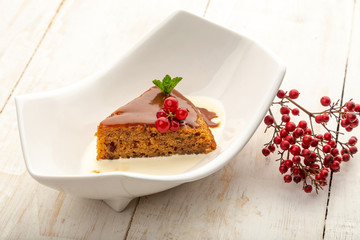 date cupcake on cream in a white plate on a light background
