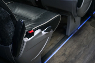 Red seatbelt clip at bus seat. Seat belts are compulsory on long distance coaches in UK © Lubo Ivanko