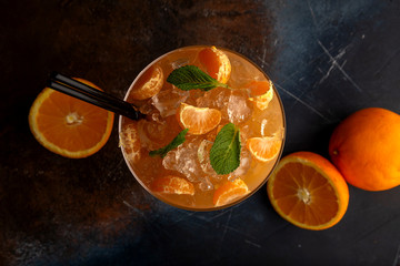 orange fresh cocktail, tangerine decoration. dark background