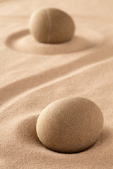 Fototapeta na wymiar two round stones in sand. Japanese rock garden stands for purity and harmony.