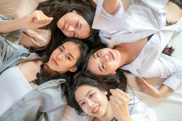 Fototapeta premium Group of beautiful pretty asian women friend on cozy bed