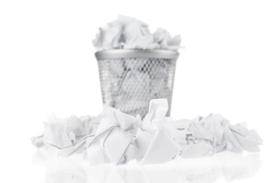 Garbage bin with waste papers on white background. Front focus