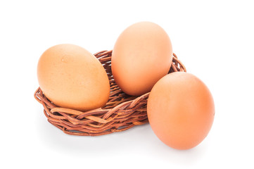 Eggs in basket isolated on white background