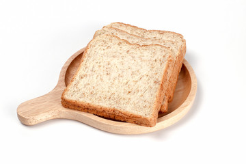 Whole grain bread. Whole wheat bread. Toast wheat bread sliced on wooden plate isolated on white background