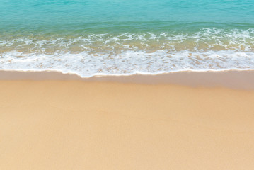 Fototapeta na wymiar Soft wave of sea and sandy beach background.