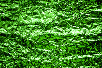 abstract textured background. green foil surface. bright packaging.