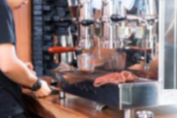 Abstract blur image of Barista is brewing a cup of coffee with bokeh for background usage. (vintage tone)