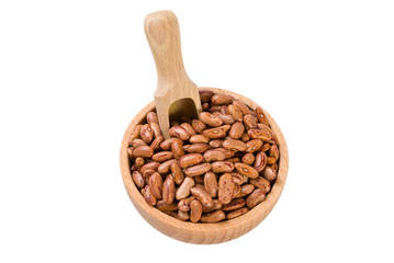 Pinto bean in wooden bowl and scoop isolated on white background. nutrition. bio. natural food ingredient.