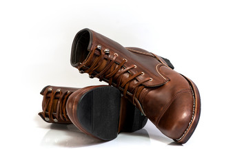 Men’s brown boots isolated on a white background.